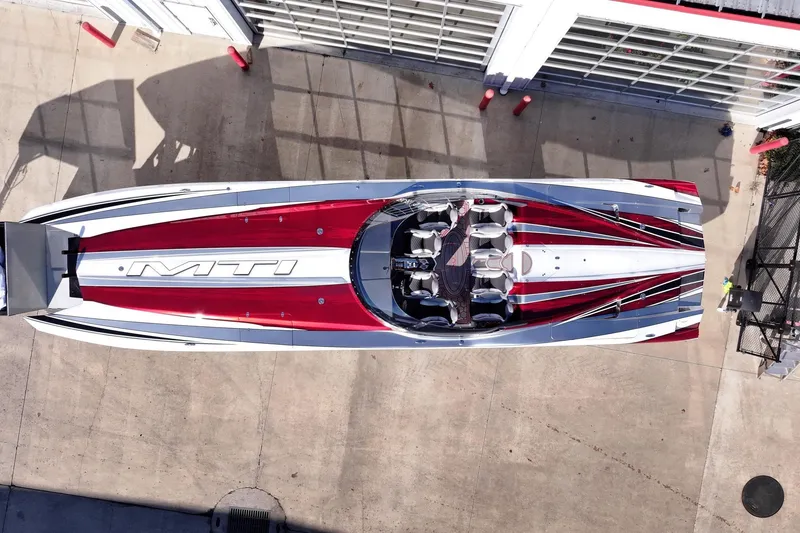 Slide: The Image of Aerial view of 2016 MTI 48 speedboat with red, white, and black design. - 26