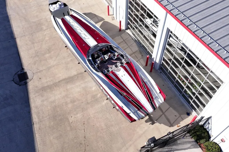 Slide: The Image of Aerial view of 2016 MTI 48 speedboat with red and white design near a garage. - 27