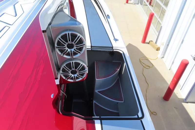Slide: The Image of 2016 MTI 48 boat with open storage compartment and dual speakers. - 36