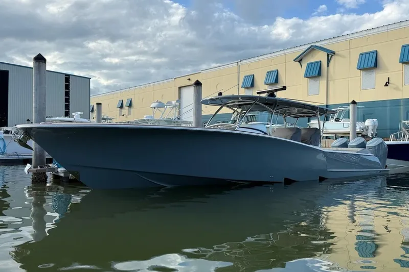 The Image of 2026 Mag Bay 43 CC boat on calm water under clear blue sky. - 0