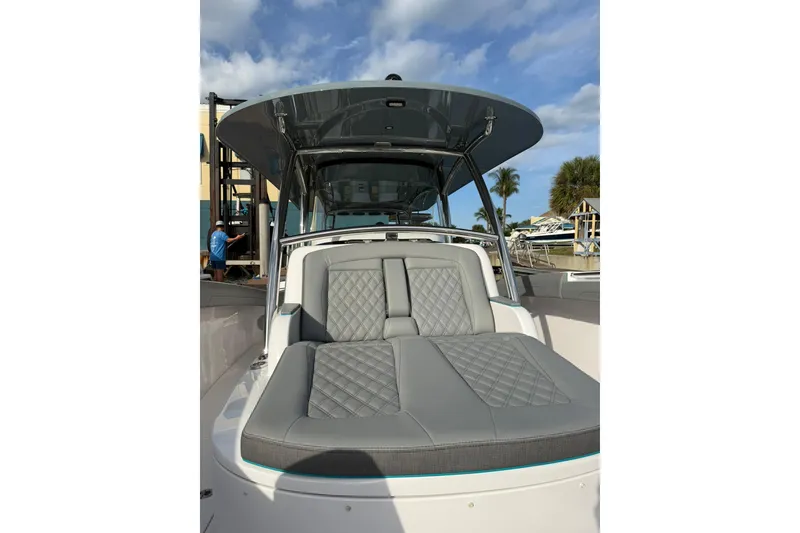 Slide: The Image of 2026 Mag Bay 43 CC boat interior with luxurious seating at sunset on calm water. - 21