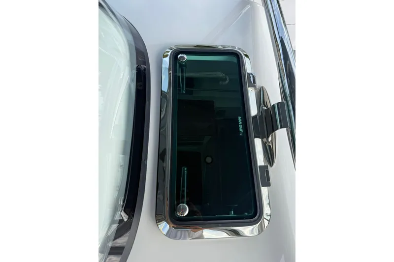 Slide: The Image of 2026 Mag Bay 43 CC boat interior with seating and outboard motors at sunset. - 24