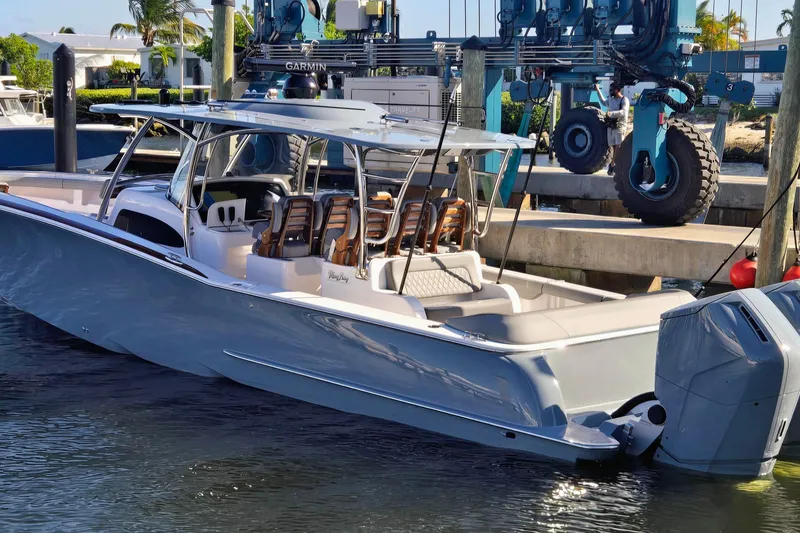 Slide: The Image of 2026 Mag Bay 43 CC boat on calm water at sunset. - 3