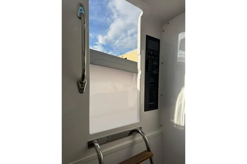 Slide: The Image of 2026 Mag Bay 43 CC boat dashboard with advanced navigation screens and controls. - 32