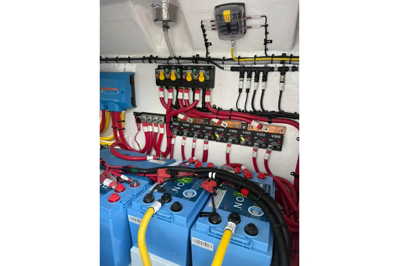 Slide: The Image of 2026 Mag Bay 43 CC boat bathroom with sleek white design and wooden accents. - 44