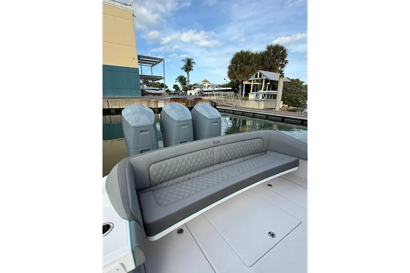 Slide: The Image of 2026 Mag Bay 43 CC boat with triple outboard engines on calm water. - 6