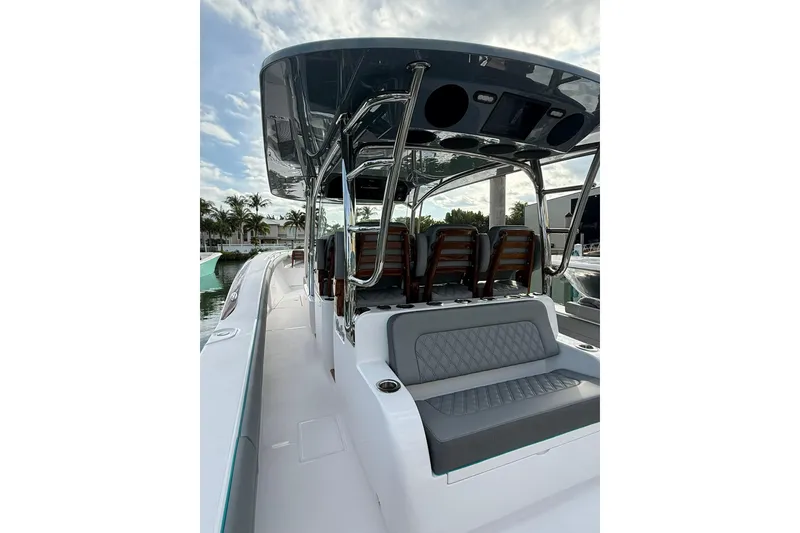 Slide: The Image of 2026 Mag Bay 43 CC boat with triple outboard engines on calm water. - 7