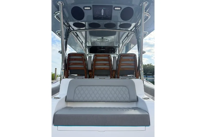 Slide: The Image of 2026 Mag Bay 43 CC boat with triple outboard engines on calm water. - 8