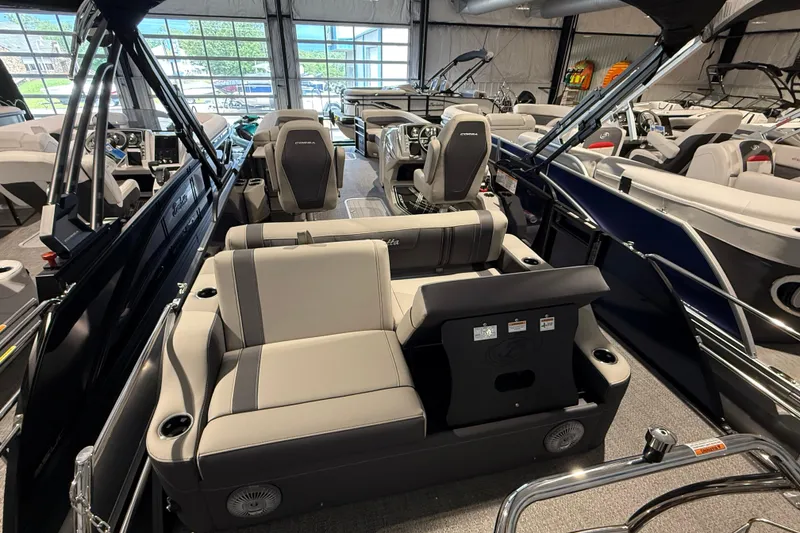 Slide: The Image of 2025 Barletta CORSA 25UC pontoon boat interior with luxurious seating in showroom. - 15