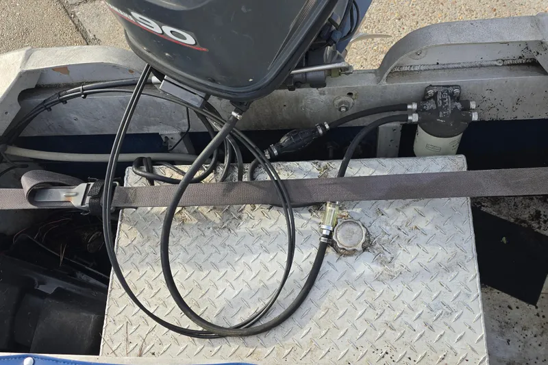 Slide: The Image of Outboard motor setup on 1976 Custom Aluminum 16 boat with fuel lines and diamond plate flooring. - 8