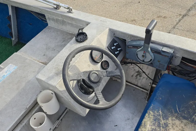 Slide: The Image of Steering console of a 1976 Custom Aluminum 16 boat with controls and gauges. - 9