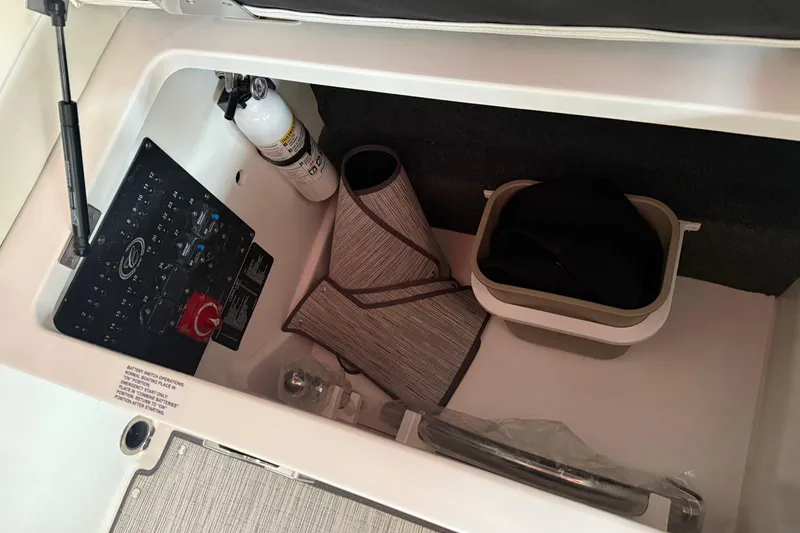 Slide: The Image of Storage compartment in 2025 Cobalt R6 boat with fire extinguisher and accessories. - 17