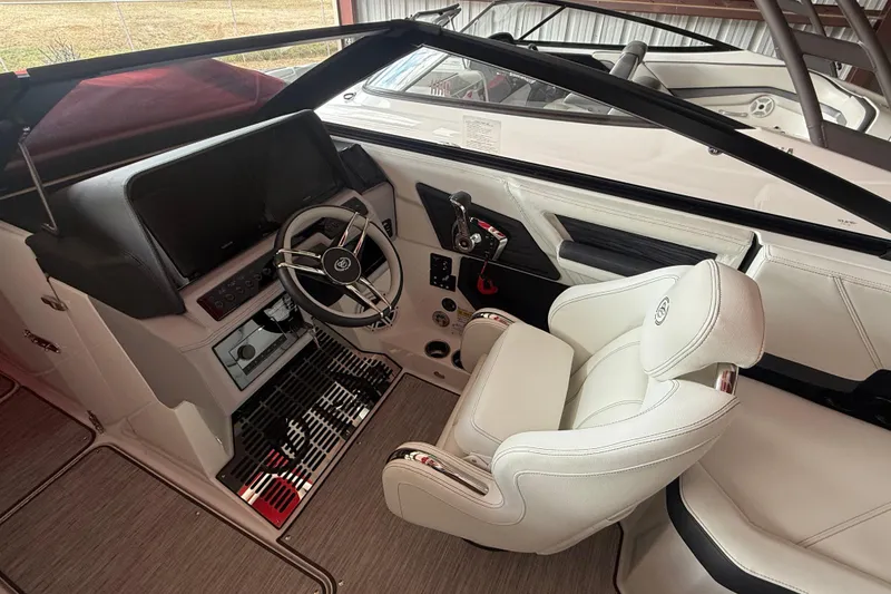 Slide: The Image of 2025 Cobalt R6 boat interior with white captain's chair and modern dashboard. - 23