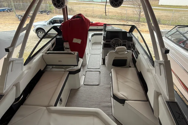 Slide: The Image of 2025 Cobalt R6 boat interior with white seating and modern dashboard design. - 24