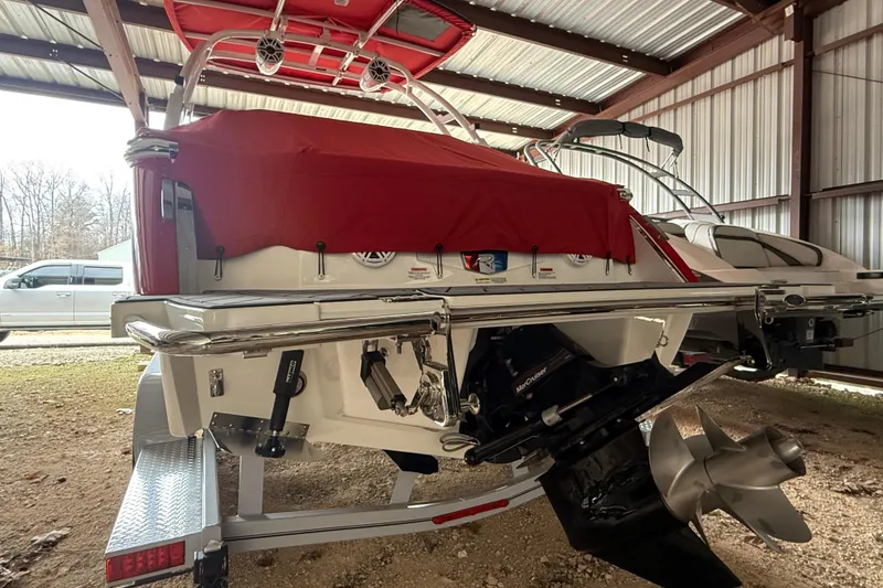 Slide: The Image of 2025 Cobalt R6 boat with red cover, stored indoors, featuring a powerful engine. - 3