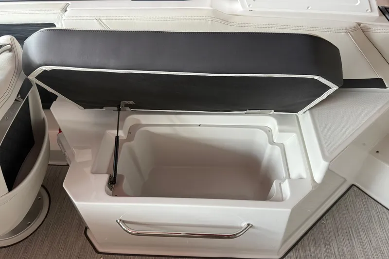 Slide: The Image of 2025 Cobalt R6 boat seat storage compartment open, showcasing interior space. - 9