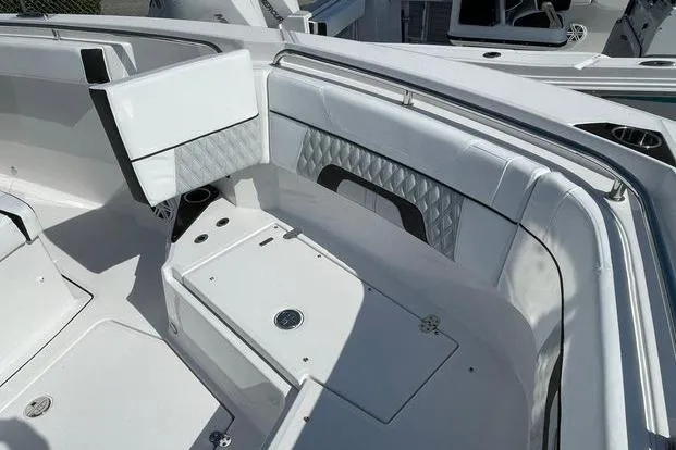 Slide: The Image of 2026 Blackfin 272 CC boat interior with white seating and storage compartments. - 4