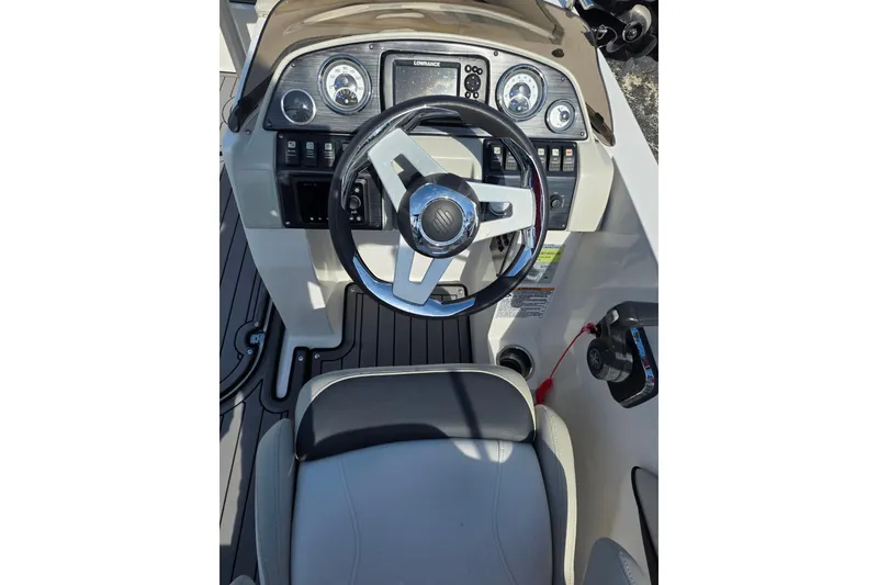 Slide: The Image of 2022 Starcraft MDX 191 E O/B boat dashboard with steering wheel and controls. - 13