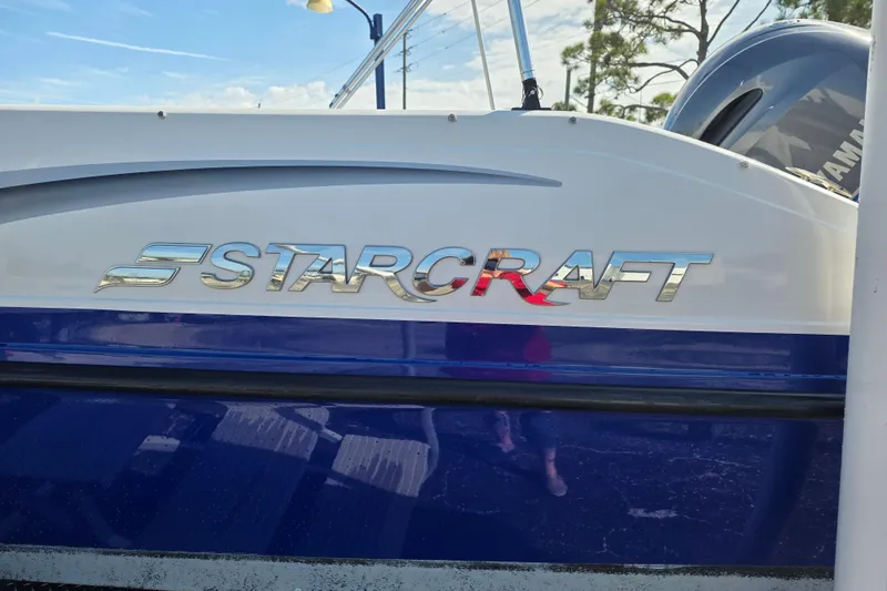 Slide: The Image of 2022 Starcraft MDX 191 E O/B boat with sleek blue and white design. - 6
