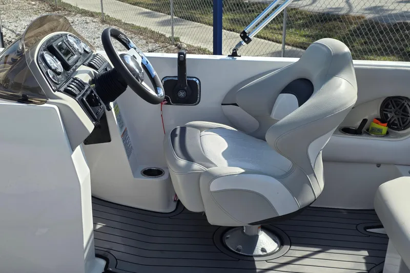 Slide: The Image of 2022 Starcraft MDX 191 E O/B boat interior with steering wheel and captain's chair. - 8