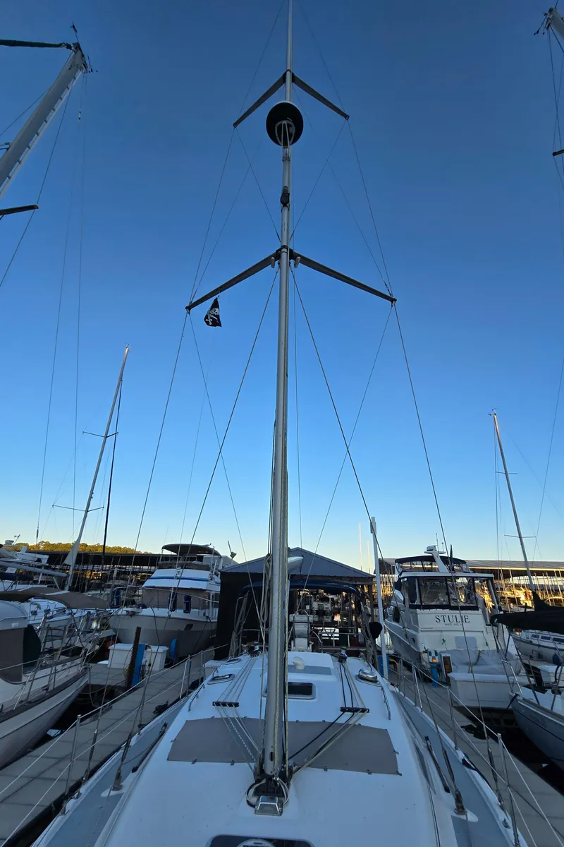 Slide: The Image of 2004 Hunter 41 AC sailboat docked at marina, mast view under clear sky. - 13