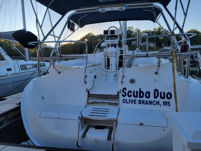 Slide: The Image of 2004 Hunter 41 AC sailboat named "Scuba Duo" docked at a marina. - 15
