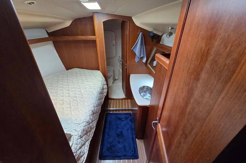 Slide: The Image of Cozy cabin interior of 2004 Hunter 41 AC sailboat with bed and bathroom. - 31