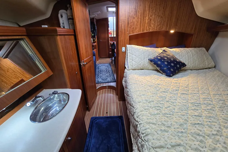 Slide: The Image of Luxurious 2004 Hunter 41 AC yacht interior with cozy bedroom and elegant wood finish. - 33