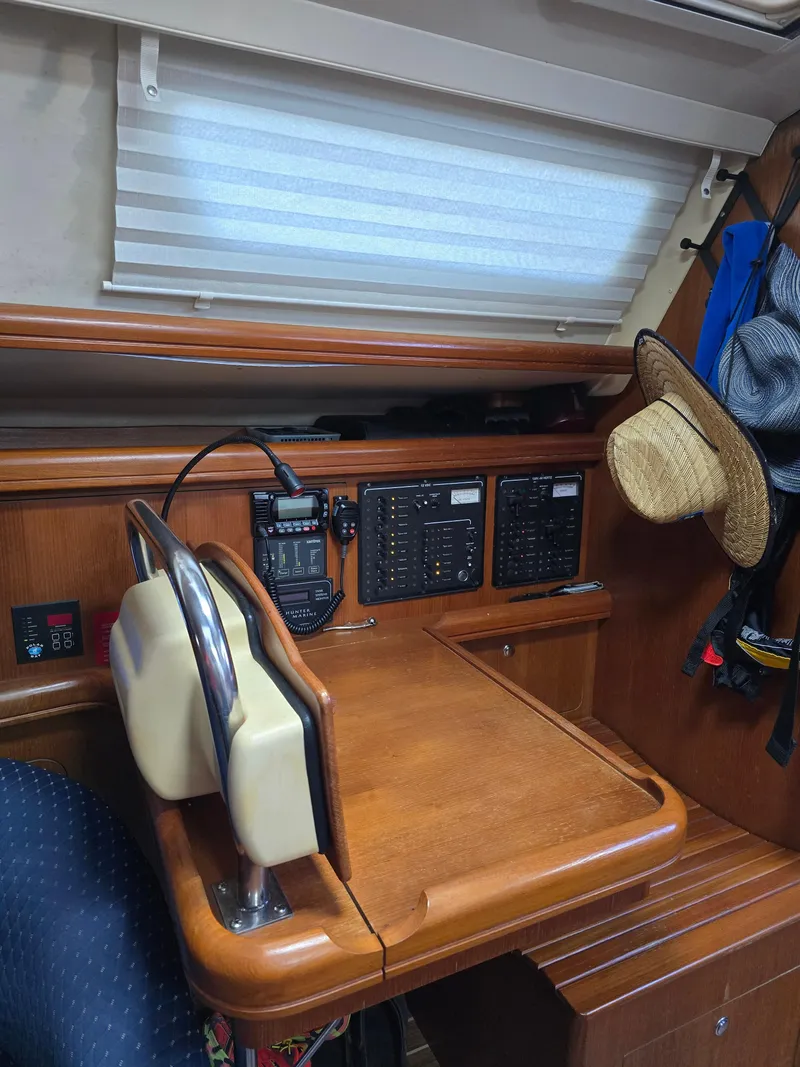 Slide: The Image of 2004 Hunter 41 AC yacht interior with navigation station and control panels. - 37