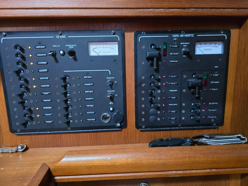 Slide: The Image of Control panels on a 2004 Hunter 41 AC boat, featuring 12VDC and 120V-60 Hertz systems. - 38