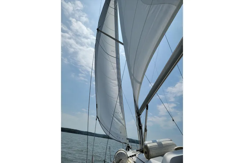 Slide: The Image of Sailing on a 2004 Hunter 41 AC yacht with full sails under a clear sky. - 4