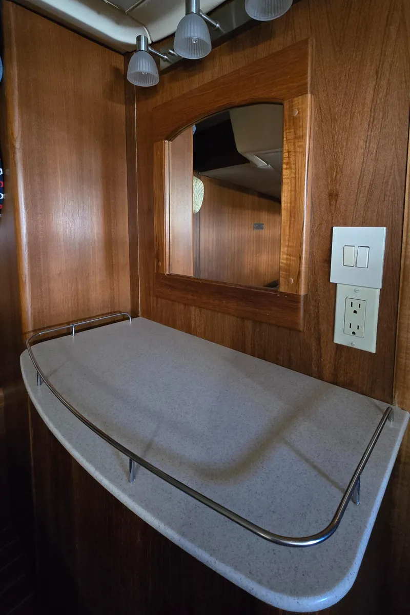 Slide: The Image of Wooden interior of a 2004 Hunter 41 AC yacht with a countertop and mirror. - 42