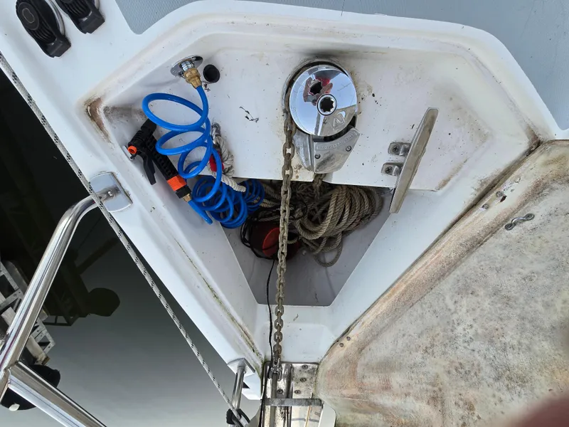 Slide: The Image of Anchor locker of 2004 Hunter 41 AC sailboat with chain, ropes, and coiled hose. - 48