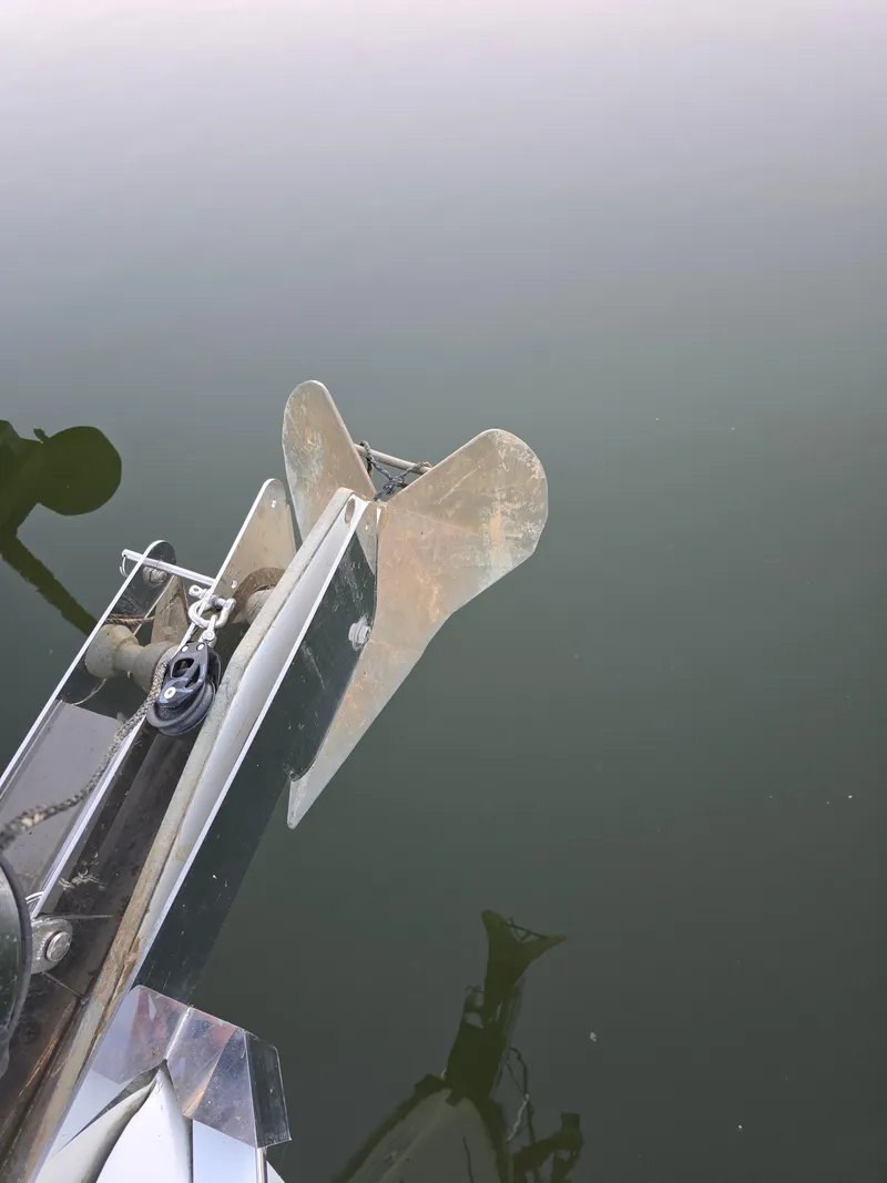 Slide: The Image of Anchor of 2004 Hunter 41 AC sailboat over calm water. - 49