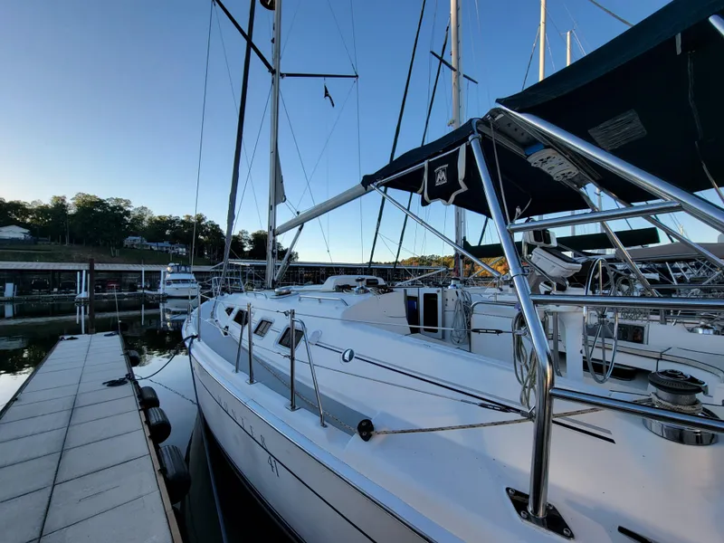 Slide: The Image of 2004 Hunter 41 AC sailboat docked at marina, clear sky, calm water. - 8