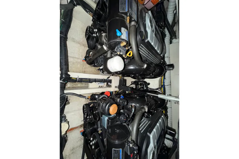 Slide: The Image of Engine compartment of a 2018 Rinker EX 320 boat, showcasing dual engines. - 29
