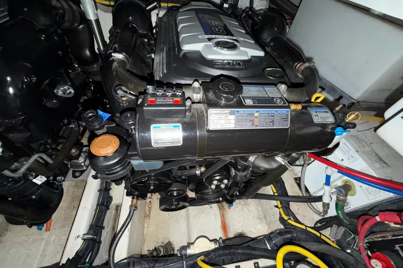 Slide: The Image of Engine compartment of a 2018 Rinker EX 320 boat, featuring a Mercury engine. - 30