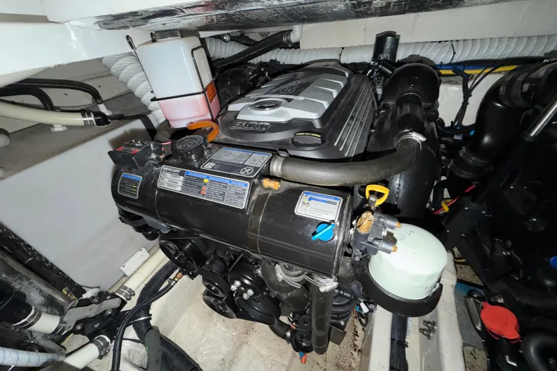 Slide: The Image of Engine compartment of a 2018 Rinker EX 320 boat, featuring a Mercury engine. - 31
