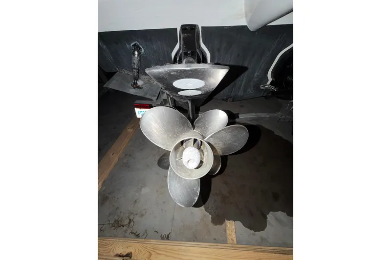 Slide: The Image of 2018 Rinker EX 320 boat propeller in a garage setting. - 36
