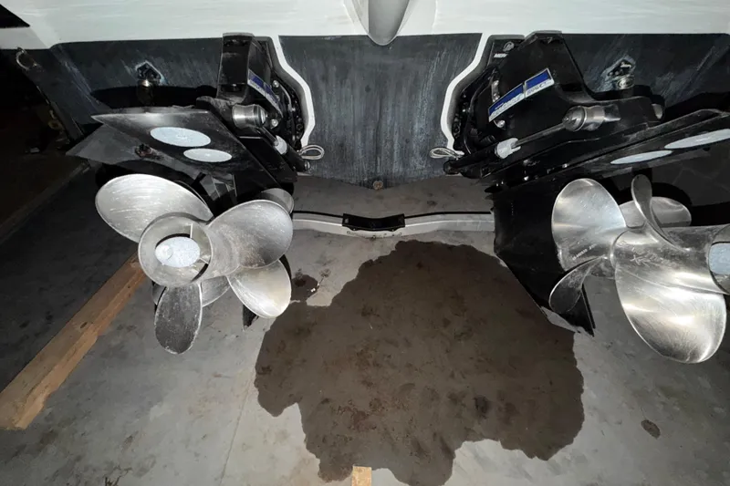 Slide: The Image of 2018 Rinker EX 320 boat propellers in a garage setting. - 37