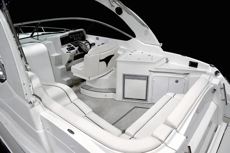Slide: The Image of Manufacturer Provided Image: 2018 Rinker EX 320 boat interior with white seating and control panel. - 4
