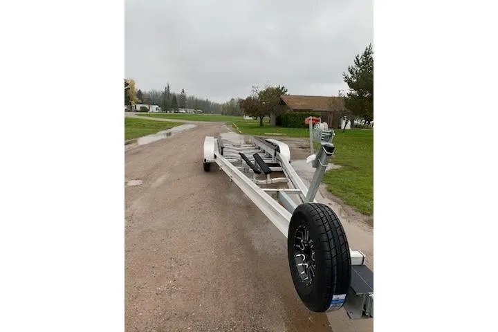 Slide: The Image of Trailer for 2018 Rinker EX 320 boat on a rural road. - 40