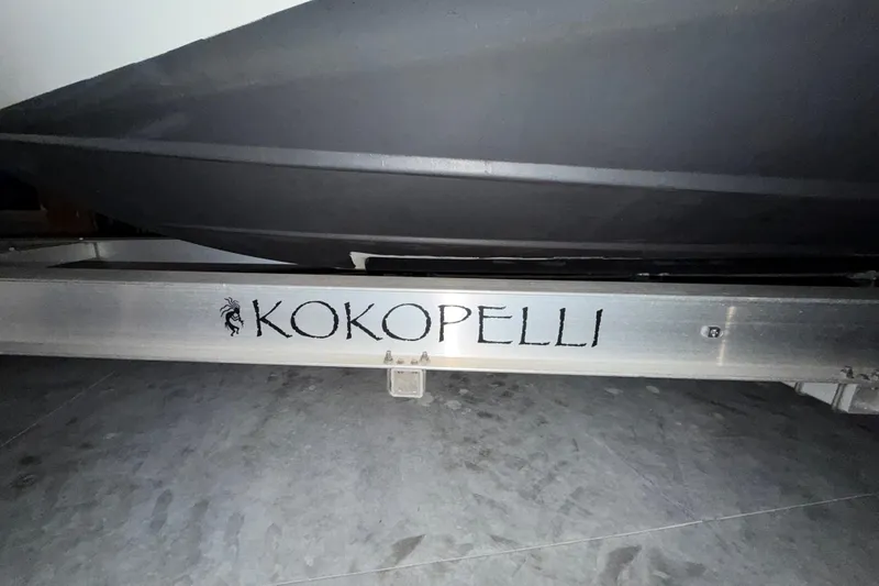Slide: The Image of 2018 Rinker EX 320 boat trailer with "Kokopelli" text on metal frame. - 41