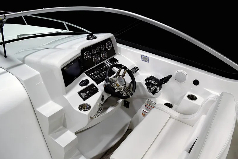 Slide: The Image of Manufacturer Provided Image: 2018 Rinker EX 320 boat helm with modern controls and white seating. - 5