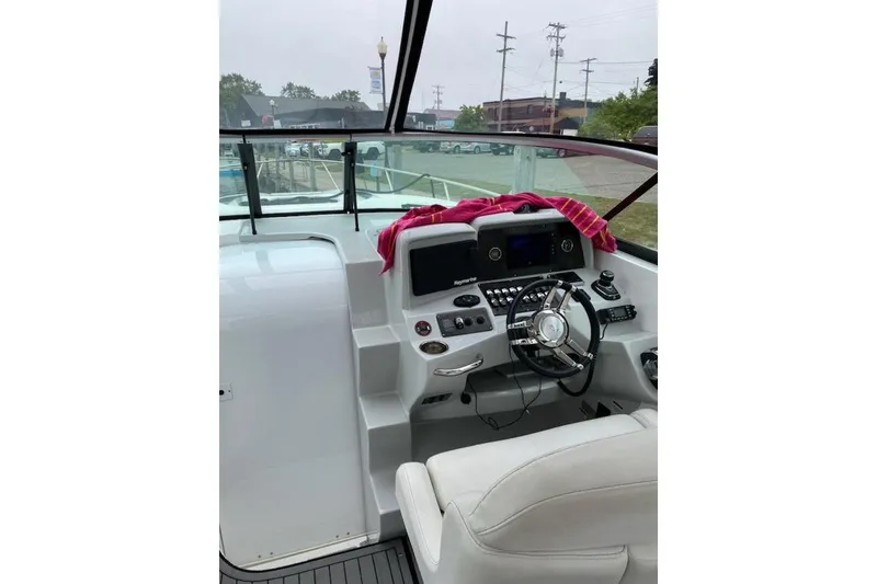 Slide: The Image of 2018 Rinker EX 320 boat cockpit with steering wheel and dashboard controls. - 7