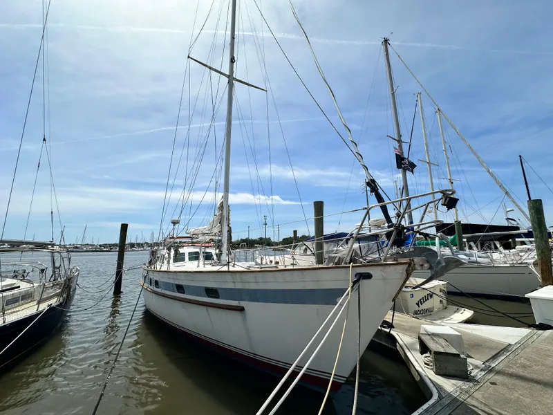Slide: The Image of 1982 Pan Oceanic 43 sailboat docked at marina under clear blue sky. - 0