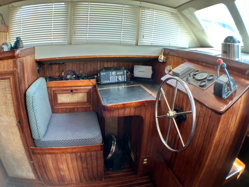 Slide: The Image of 1982 Pan Oceanic 43 yacht interior with wooden helm, steering wheel, and navigation equipment. - 10