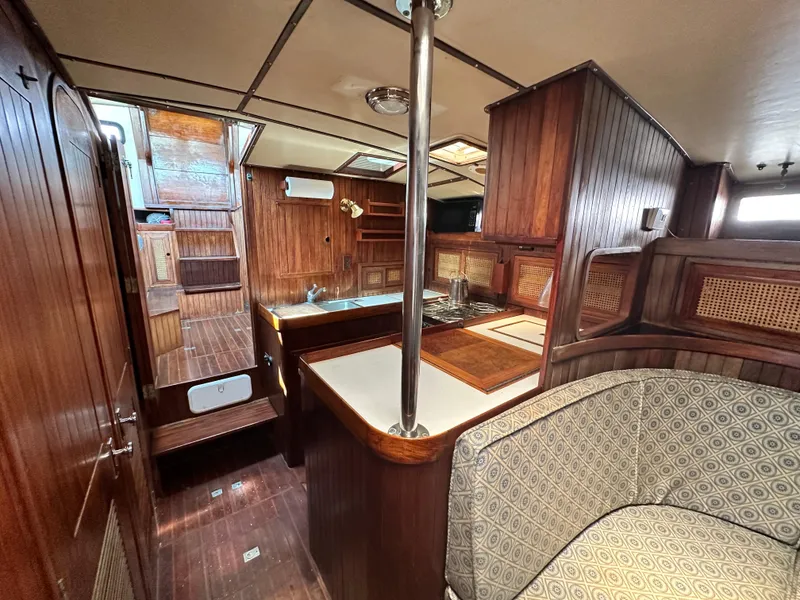Slide: The Image of Interior of 1982 Pan Oceanic 43 sailboat with wooden cabinetry and cozy seating area. - 12