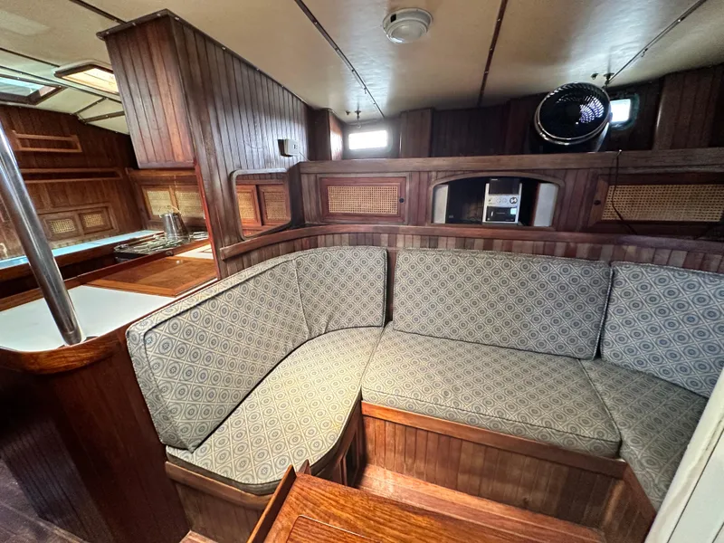 Slide: The Image of Interior of 1982 Pan Oceanic 43 yacht with wooden finish and patterned seating. - 13