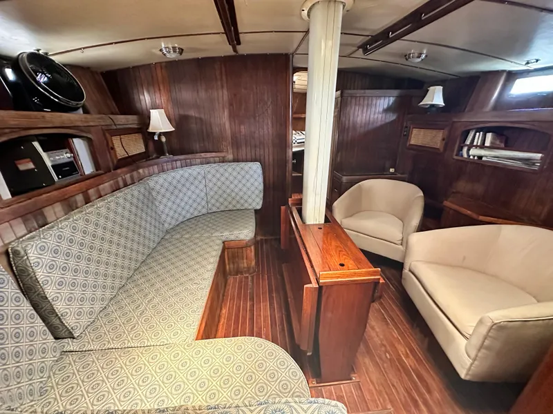 Slide: The Image of Interior of 1982 Pan Oceanic 43 yacht with wooden paneling and cozy seating area. - 14